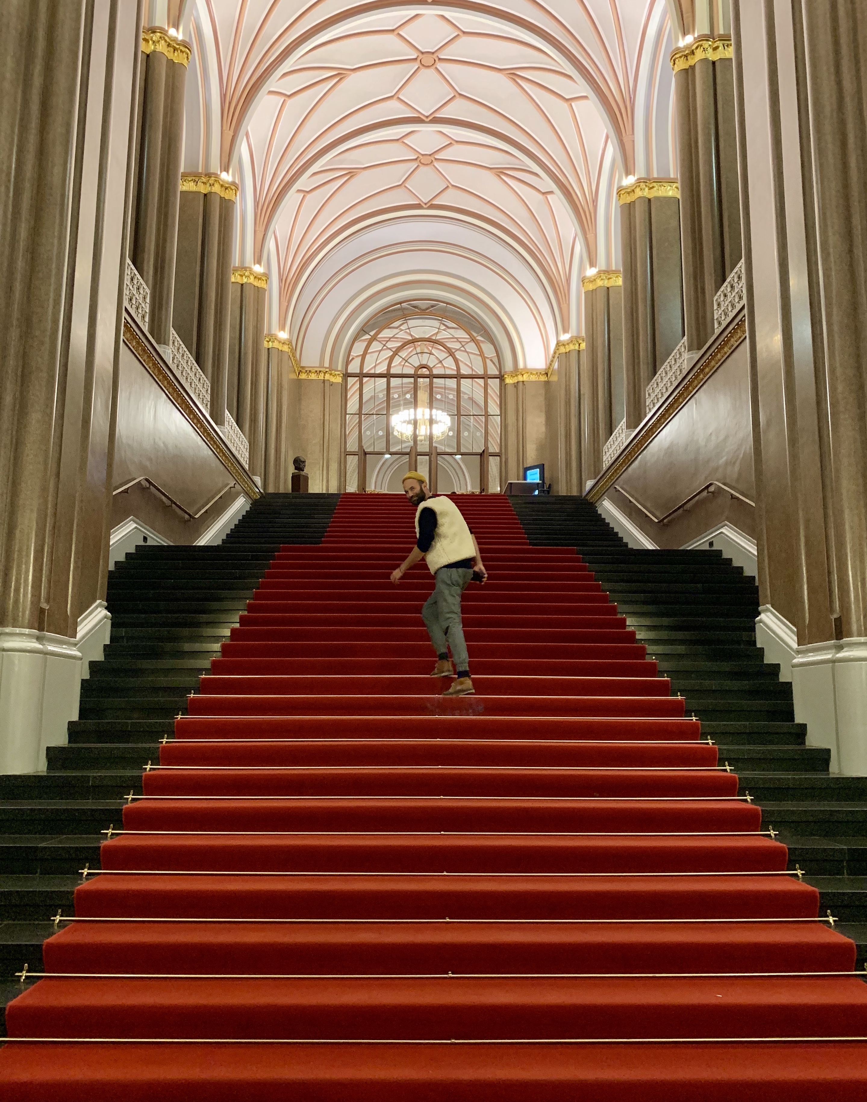 Person auf Treppe im roten Rathaus